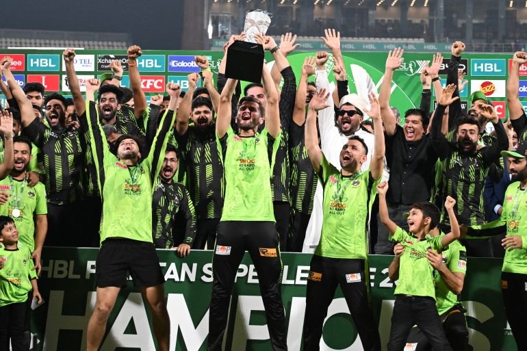 Lahore Qalandars' captain Shaheen Shah Afridi celebrates with the trophy during the victory ceremony at the Pakistan Super League final match against Quetta Gladiators at Qaddafi Cricket Stadium on May 25, 2025. (Photo by Aamir QURESHI / AFP)