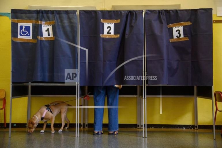 A dog waits as its owner votes in Milan for citizenship and job protection referendums, June 8, 2025. [Claudio Furlan/LaPresse via AP]