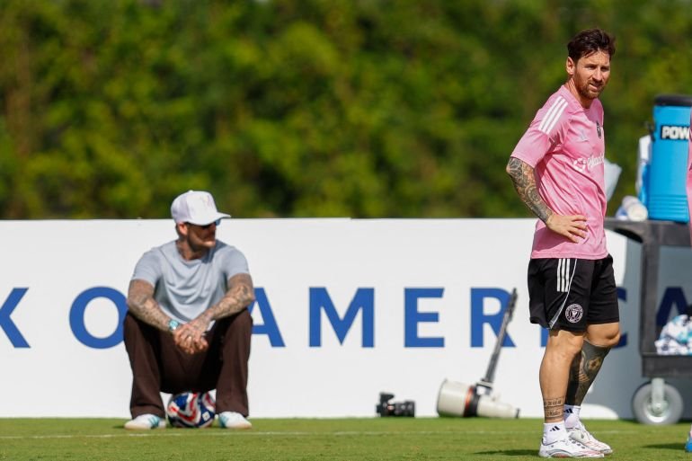 David Beckham observing Lionel Messi during training for the upcoming Club World Cup match