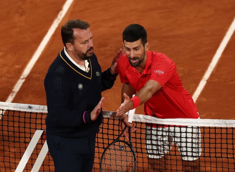 Serbia's Novak Djokovic conversing with umpire Damien Dumusois during his semifinal match against Jannik Sinner