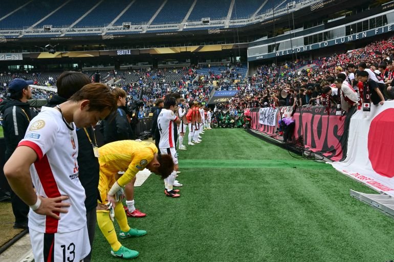 Players from Urawa Red Diamonds acknowledge their supporters following a defeat to Inter Milan at the FIFA Club World Cup 2025 on June 21, 2025, at Lumen Field, Seattle. (Photo by Pablo PORCIUNCULA / AFP)