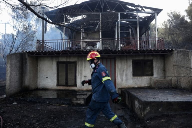 A firefighter surveys the damage in Pikermi, east of Athens, Greece, after a wildfire on July 3, 2025. [George Vitsaras/EPA]