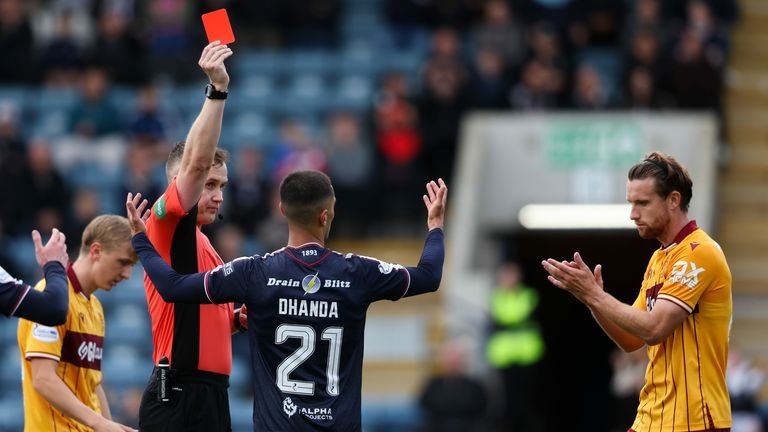 Referee Calum Scott shows a red card to Yan Dhanda of Dundee during the match against Motherwell.