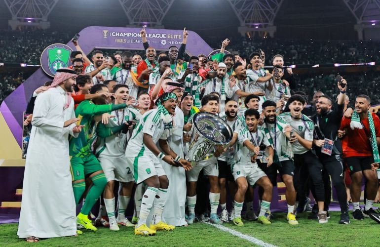 Al Ahli's Roberto Firmino lifts the trophy as he celebrates with teammates after winning the Asian Champions League
